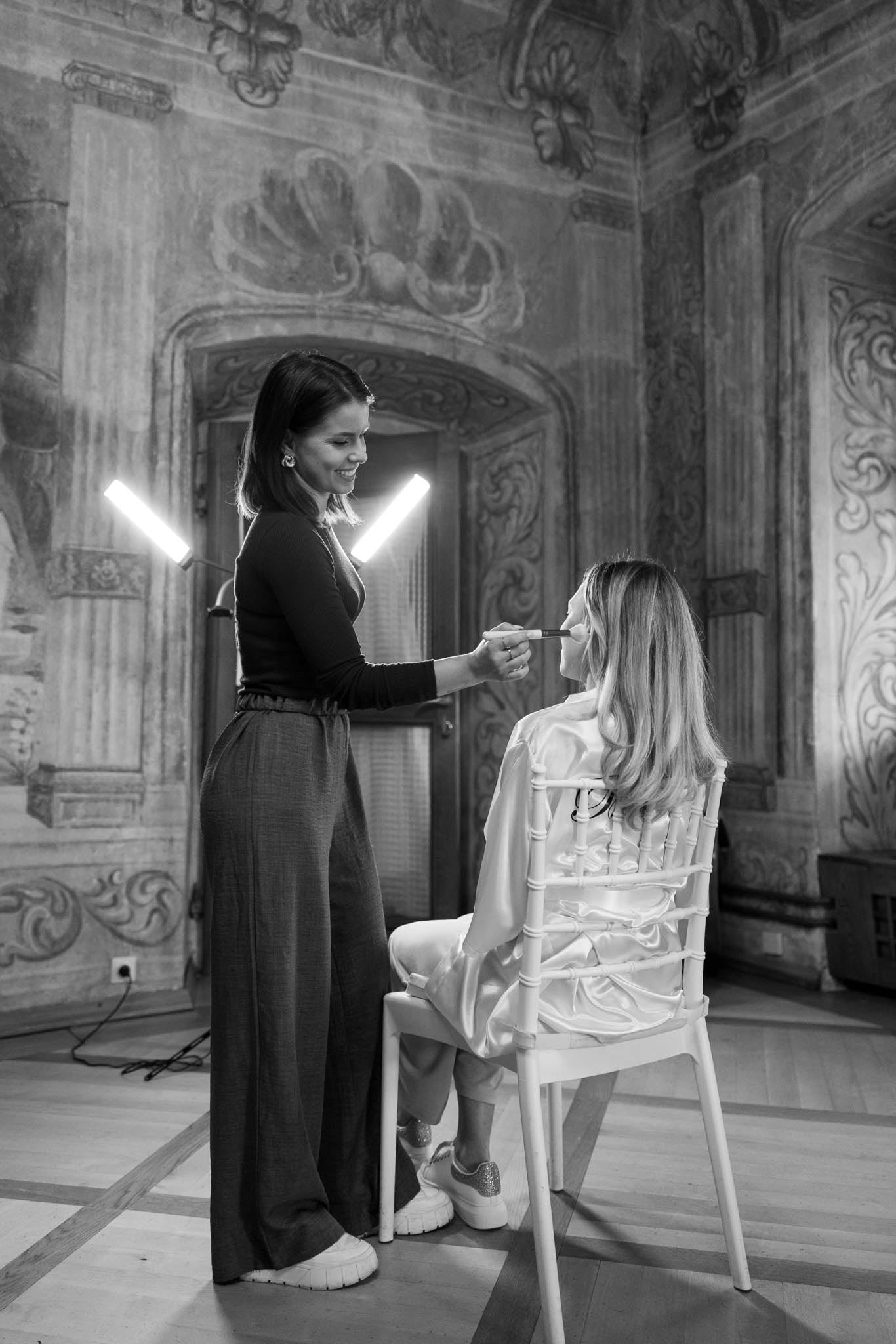 Makeup artist applying makeup to a bride in Dvorec Zemono.